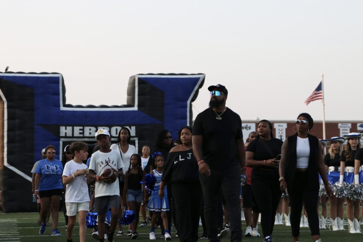 JJ Hatcher’s family and friends walk onto the field at the first home football game on Aug. 25. The game was dedicated to JJ, and the family was recognized on the field for a moment of silence.
