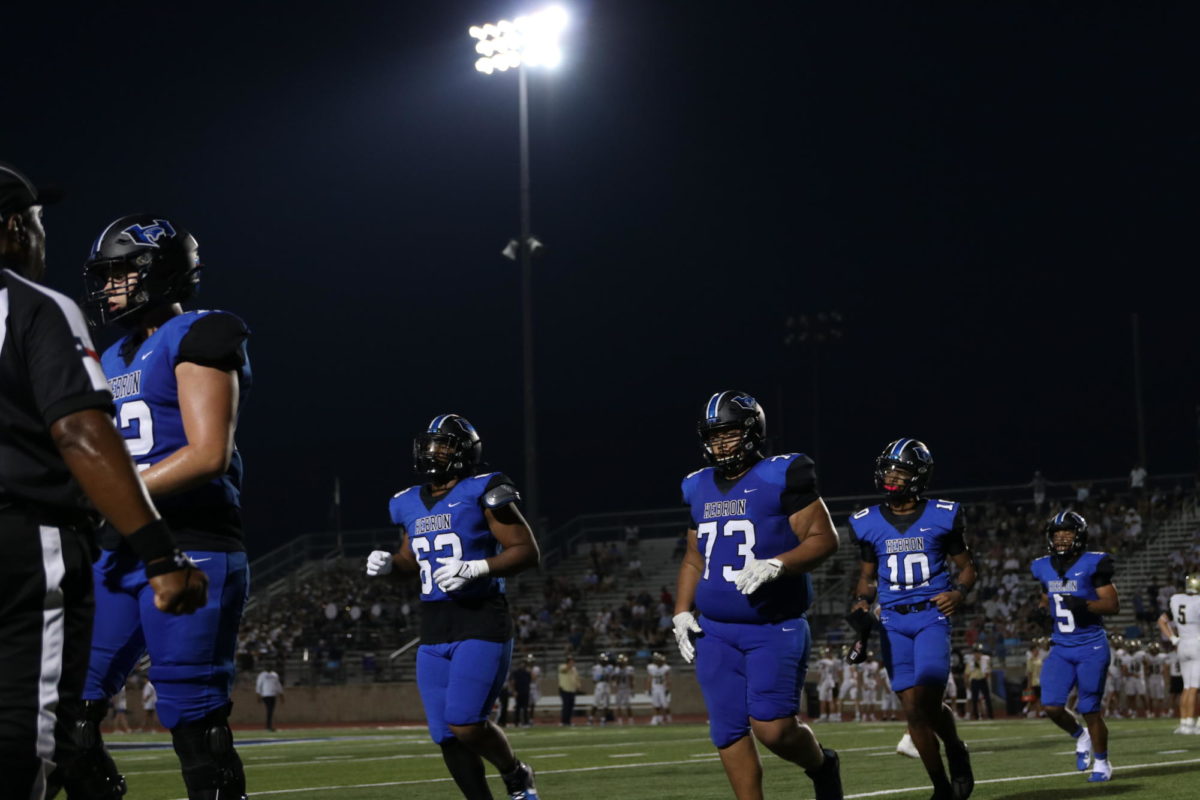 Seniors+Joshua+Johnson-Cantrell%2C+Pete+Hernandez%2C+junior+Patrick+Crayton+and+sophomore+Ayson+Mcray-Jones+run+off+the+field+in+a+game+against+Jesuit+on+Aug+25.+The+Hawks+won+against+Jesuit+by+a+score+of+39-34.+