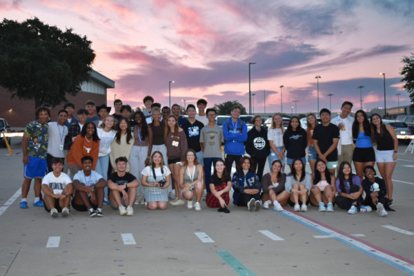 After eating breakfast and talking with each other, band seniors pose for the camera as the sun starts to rise before school on Aug. 30.
