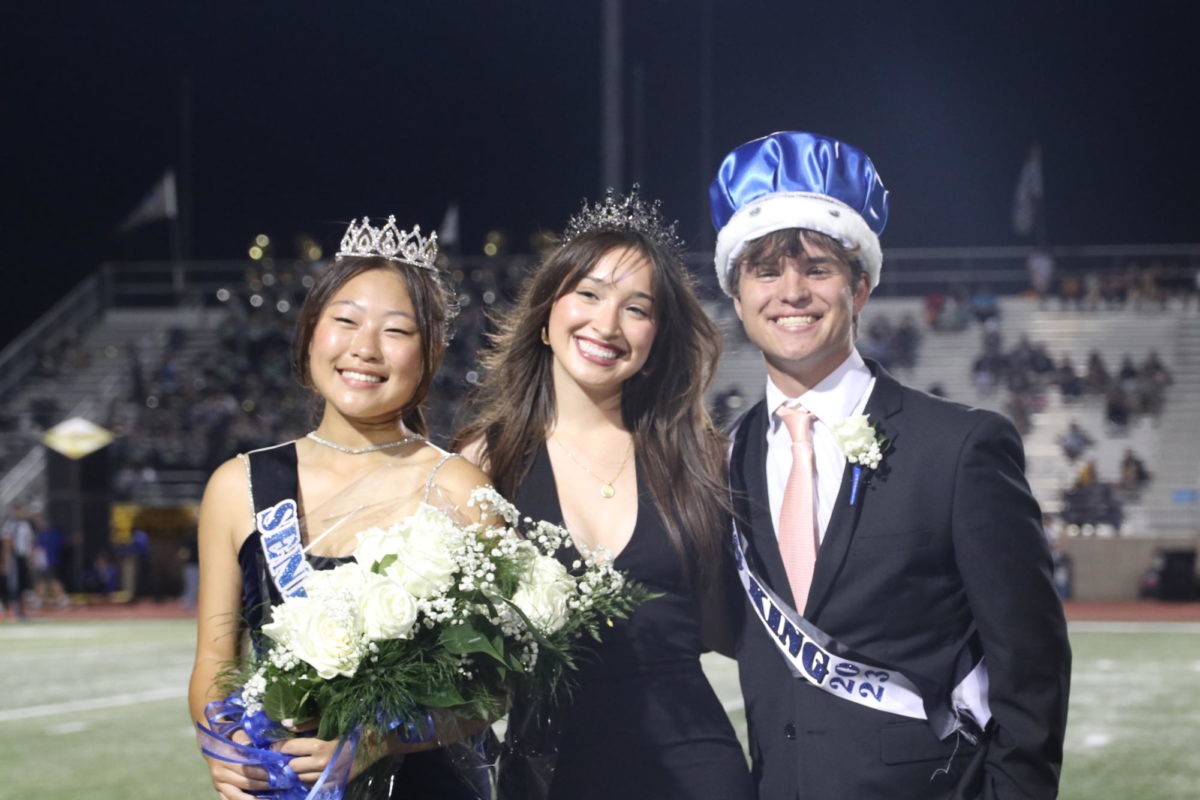 Homecoming queen Chan-Hee Kim, 2022-2023 queen Isabella Nations and Homecoming king Wesley Winkler pose for a photo. All three have been a part of the band: Kim is a drum major, Nations played the clarinet and Winkler plays the trumpet.