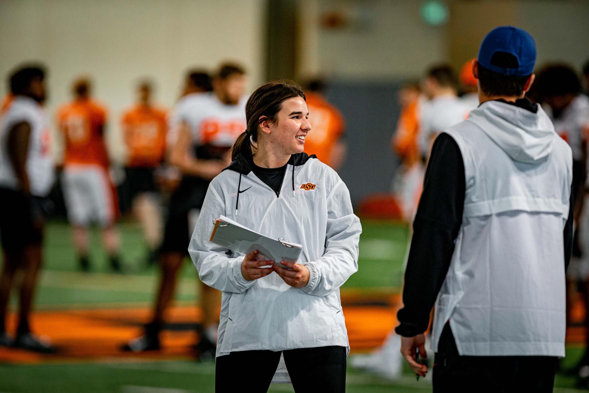 Isabel Diaz coaches the scout team wide receivers at Oklahoma State University this past fall. She graduated from OSU this May.
