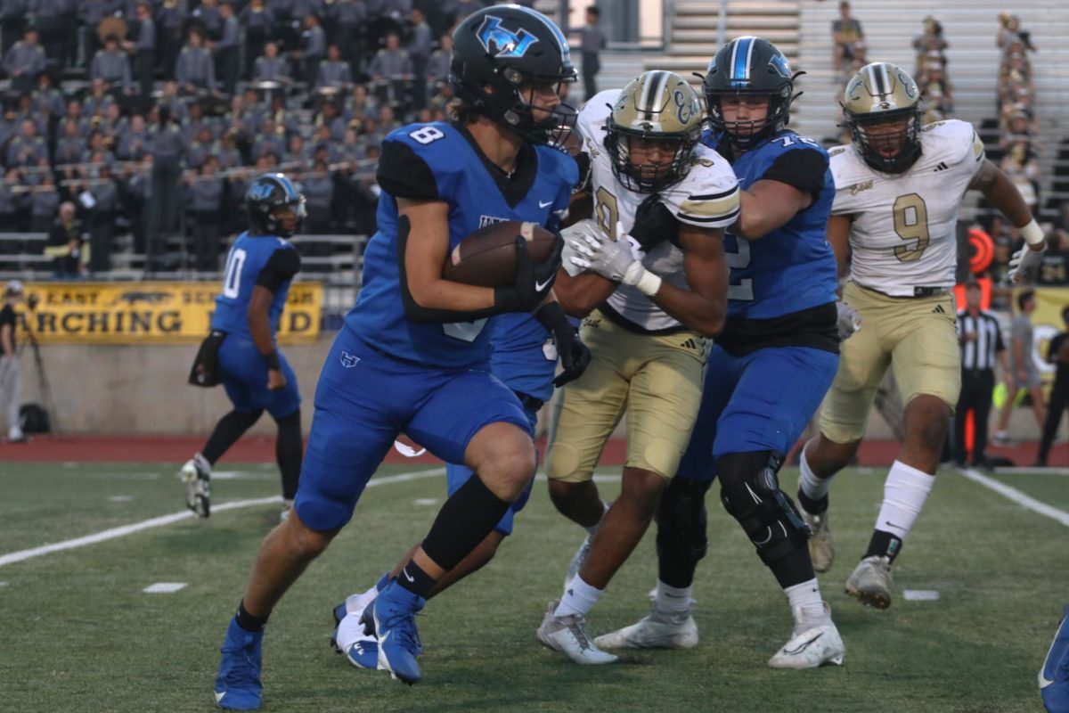 Running back Hudson Brock pushes the ball downfield in the first quarter of the Homecoming game against Plano East on Sept. 29. The team won the game 38-28.