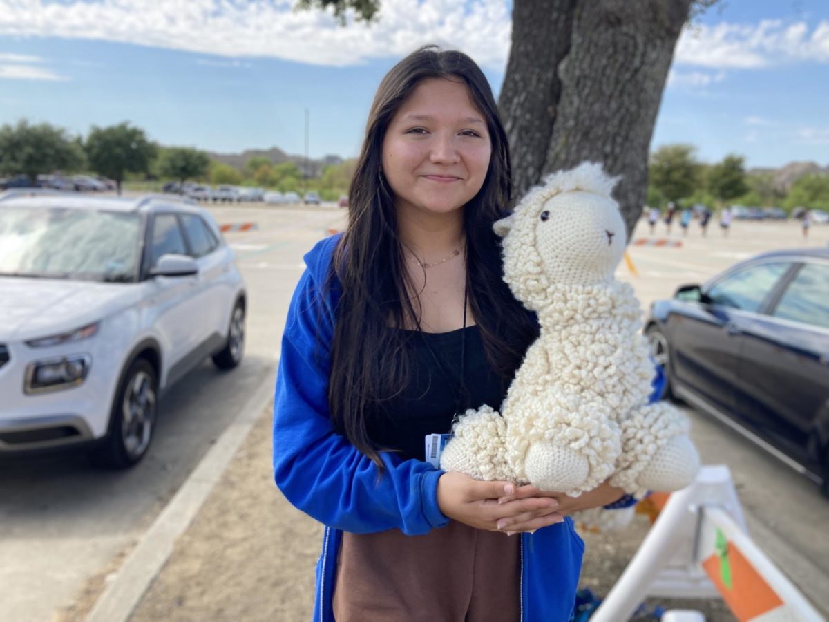  Senior Mackenzie Boyd shows off her most difficult crochet creation standing outside Hebron High School. After many attempts, she is now ready to sell it.
