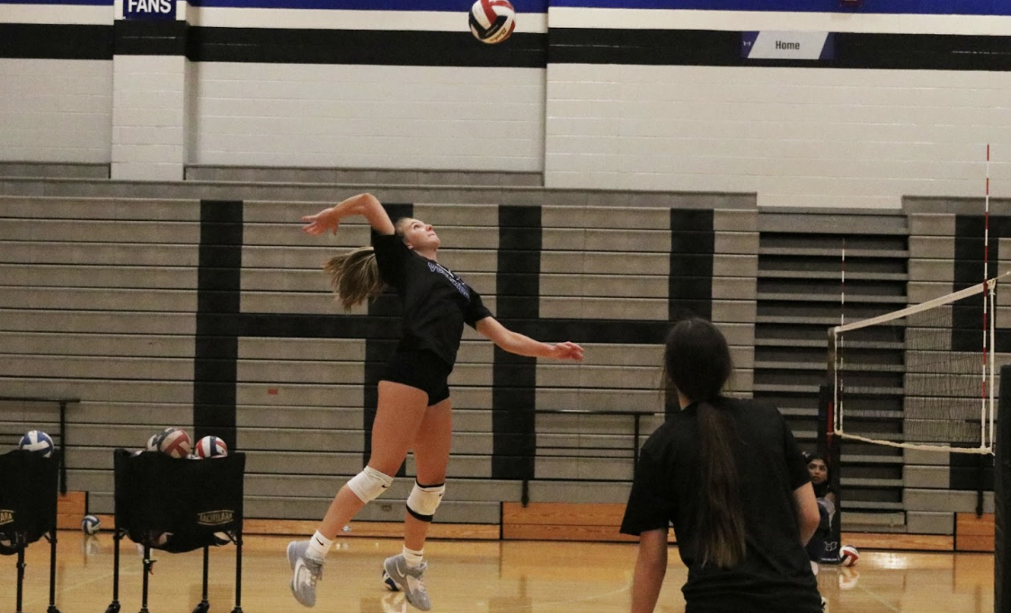 Junior Haley Kersetter jumps to slam the ball. Practices are held Monday through Thursday from 4:00 p.m. to 6:00 p.m. in preparation for upcoming games.