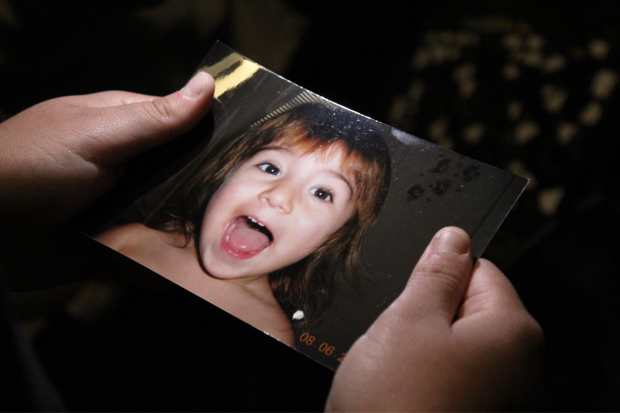 Junior Izzy Frederick holds a photo of herself when she was younger. Though she maintained high grades throughout her GT classes as a child, Izzy fell into “the wrong crowd” in middle school and her grades, along with her mental health, began to decline. “Life just got hard,” Izzy said. “Everything got dark.”