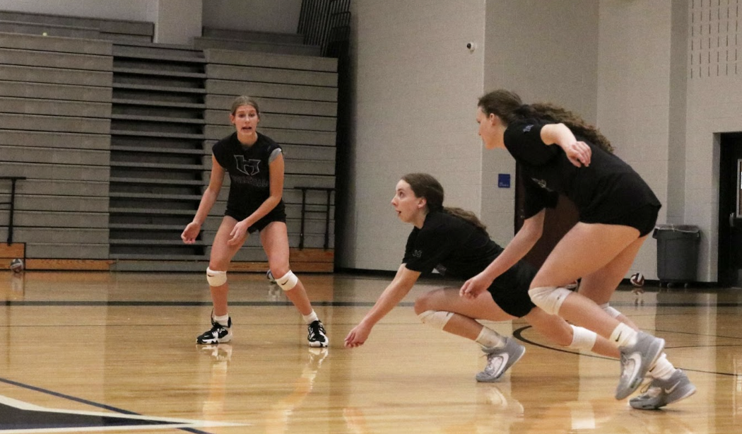 Outside+hitter+Sophie+Hoke%2C+right+side+hitter+Cadence+McDonald+and+outside+hitter+Cambria+Freymuth+get+set+to+receive+the+ball.+To+make+playoffs%2C+the+team+has+to+be+in+the+top+four+in+the+district%3B+with+just+two+games+left+in+the+regular+season%2C+the+team+is+currently+fourth.