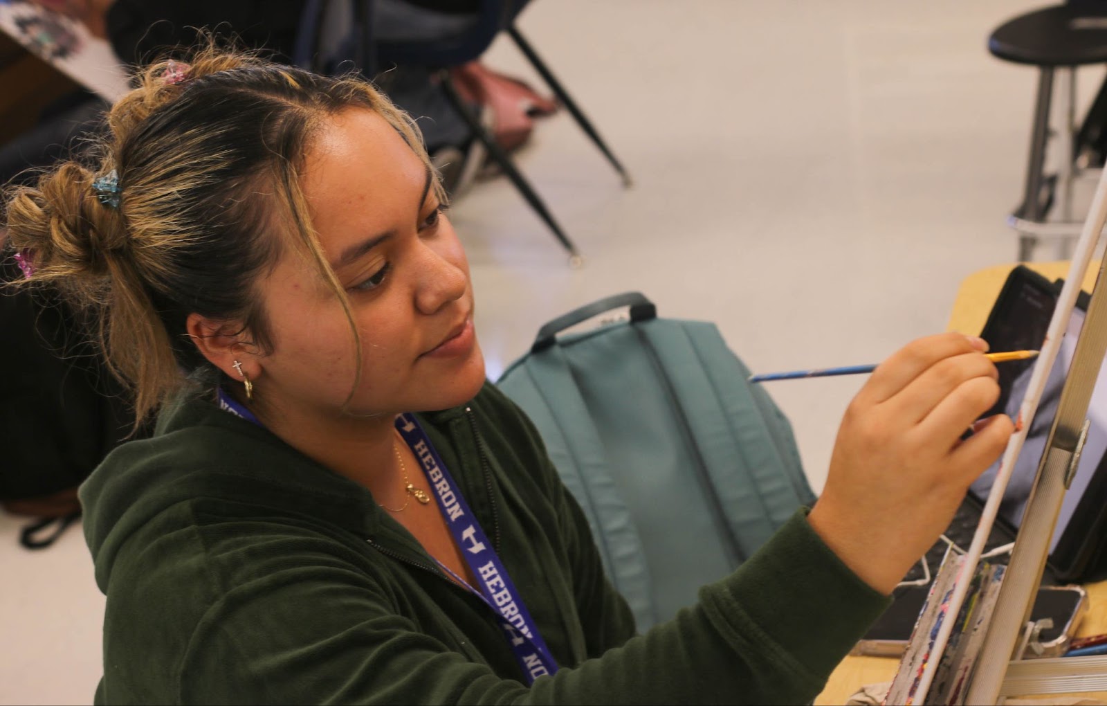  Senior Valentina Castro works on a piece in her Art 3 paint class. Castro said she has always loved and had a passion for art and is now displaying her skills and talent for all to see.