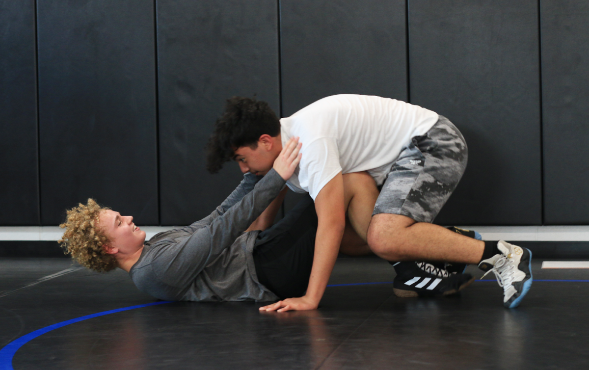 Dylan White (left) and Isaiah Solis (right) practice their wrestling moves during an after school practice on Oct. 27 in the mat rooms to prepare for the start of the season. The wrestling season will start on Nov. 2 with the Intersquad Wrestle Off in the arena at 6 p.m.