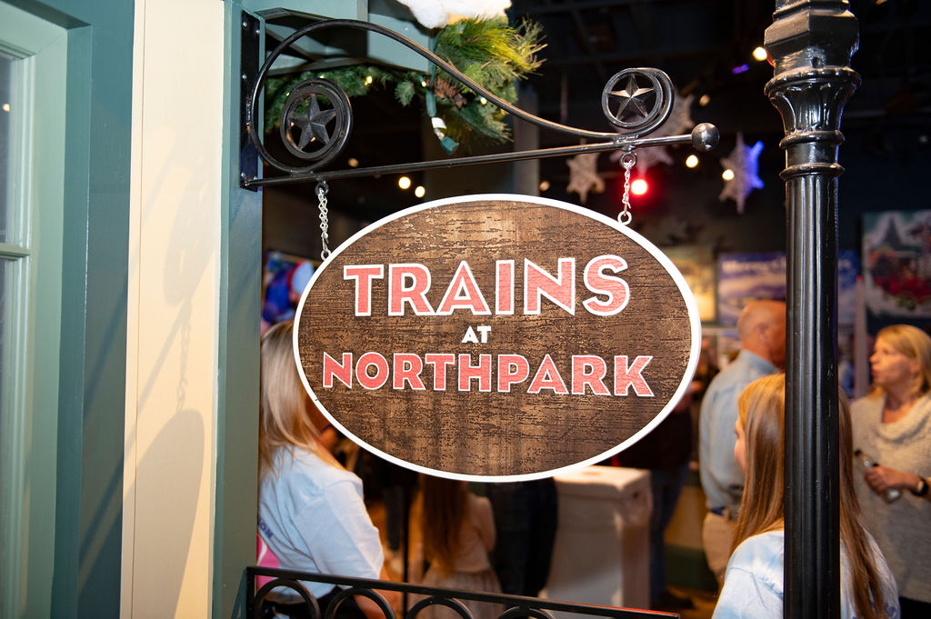The opening sign hangs at the entrance of the Train at NorthPark. This is the 36th year the event has been open, and it is the only Ronald McDonald House Charity (RMHC) to host it. 