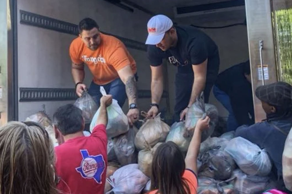 Executive director Nick Marino and volunteers load bags of food. Tango Charities holds three Guinness World Records, two for most people making sandwiches simultaneously, (1,387 people on Feb. 22, 2014 and 2,586 people on Feb. 19, 2016) and one for most sandwiches made in one hour (57,662 sandwiches on Feb. 2, 2019.)