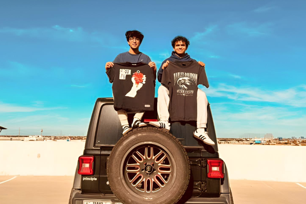 Seniors Rohin Malayil and Mathew Koithara show shirts from their latest clothing drop on Dec. 4. They received these articles of clothing from their wholesaler, Jellies World, which is located in DeSoto, Texas.