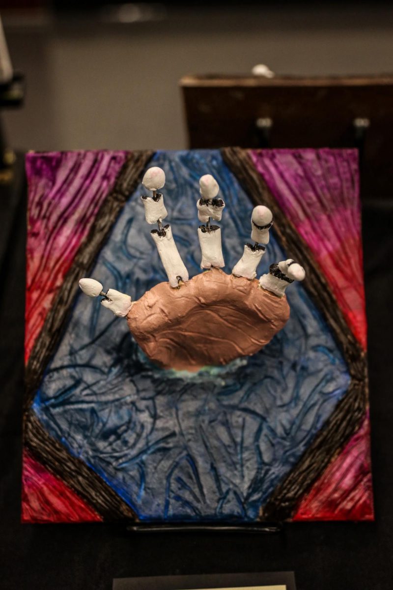 Senior Jayden Luette unveils a modern sculpture. This is their body/object sculpture, which is an art style involving the incorporation of human or animal body parts into inanimate objects or scenes.
