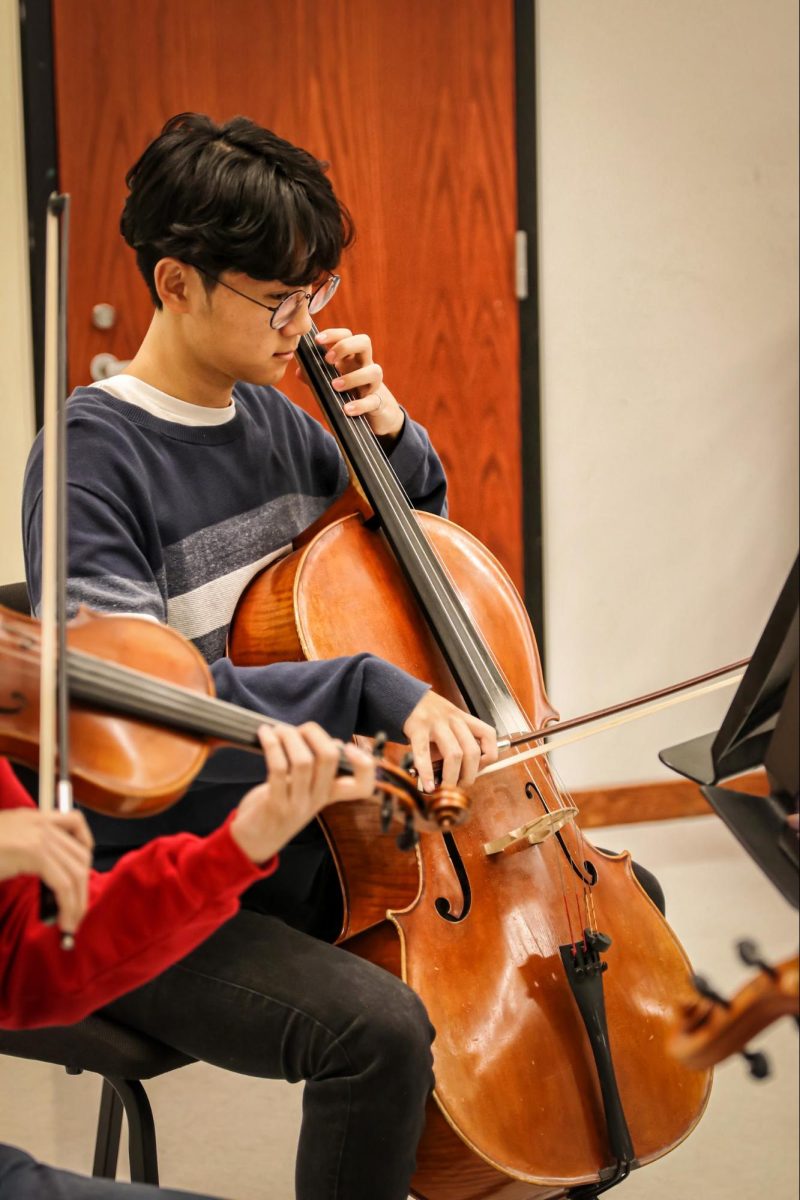 Senior Jungwoo Kim plays the cello in a string quartet along with two violins and a viola. They played Christmas music, such as “The First Noel,” “Jingle Bell Rock” and “Hark the Herald Angels Sing” during the event.