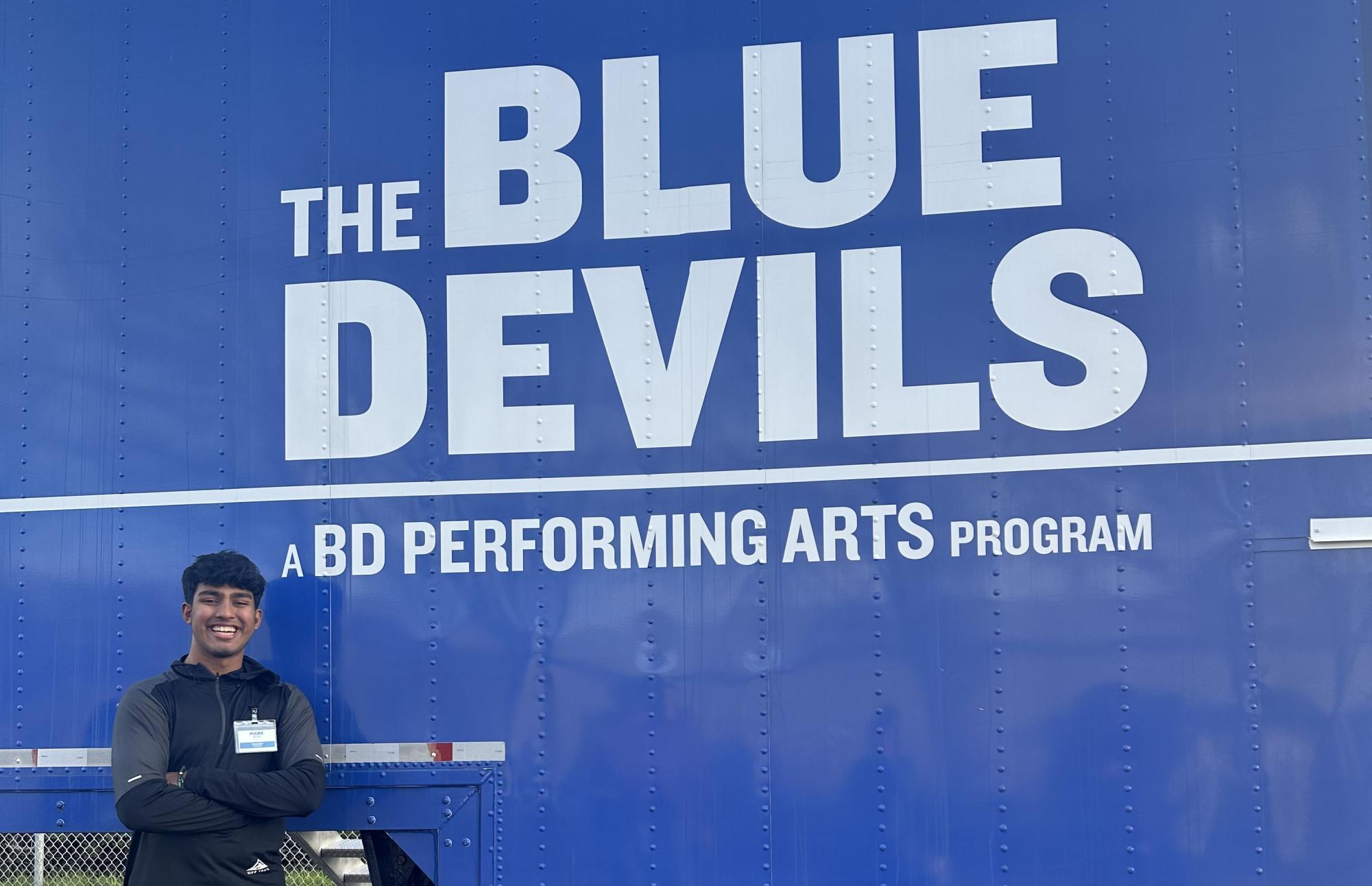  D’sa stands in front of the Blue Devils truck, moments after hearing the news of his membership. He celebrated with friend, Schmidt, who had made the group’s mellophone section. 