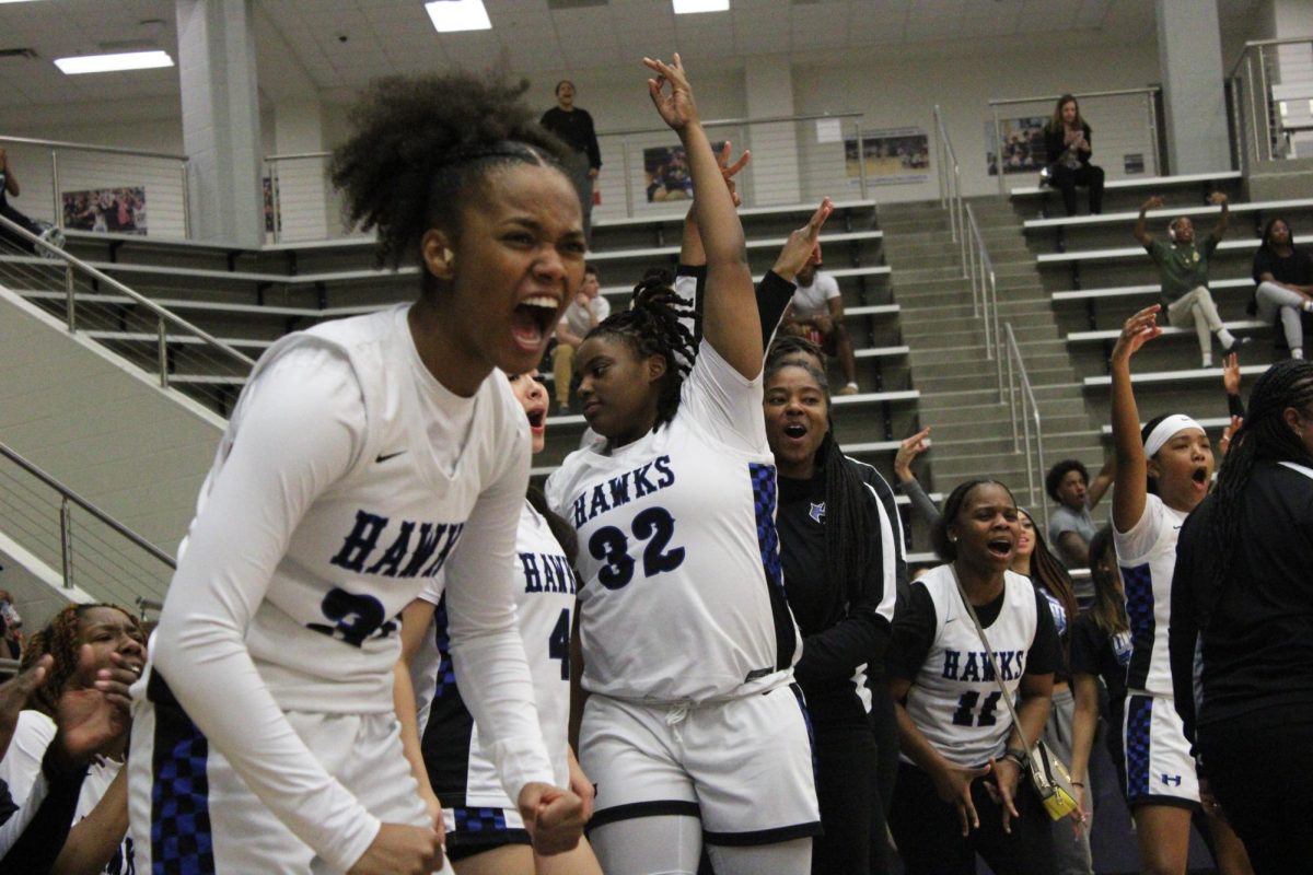 Guard Nehemiah Walker celebrates as Cooper scores a three-point jump shot with one minute left in the second quarter. The Lady Hawks were leading at halftime with a score of 25-17. 