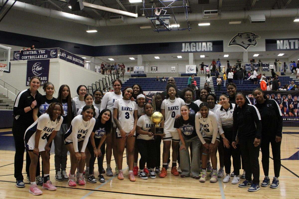 The team poses for a photo after the game. They beat Little Elm by six points with an end score of 53-47.