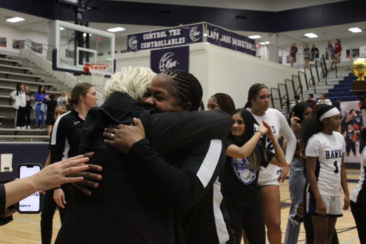 Branch hugs Boughton after the team won the quarterfinals. Last season, they were one game shy of a perfect record in districts, with a loss against Flower Mound High School. 