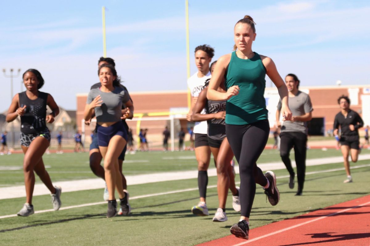Runners are practicing for the 400-meter race by running on the track at practice on Feb. 21. Track and field practice during first and fourth period, preparing for the upcoming meet. 