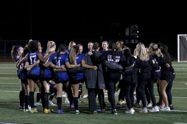 The girls soccer team does its pre-game huddle before the game begins against Coppell on Feb. 6. The team won the game 3-1.