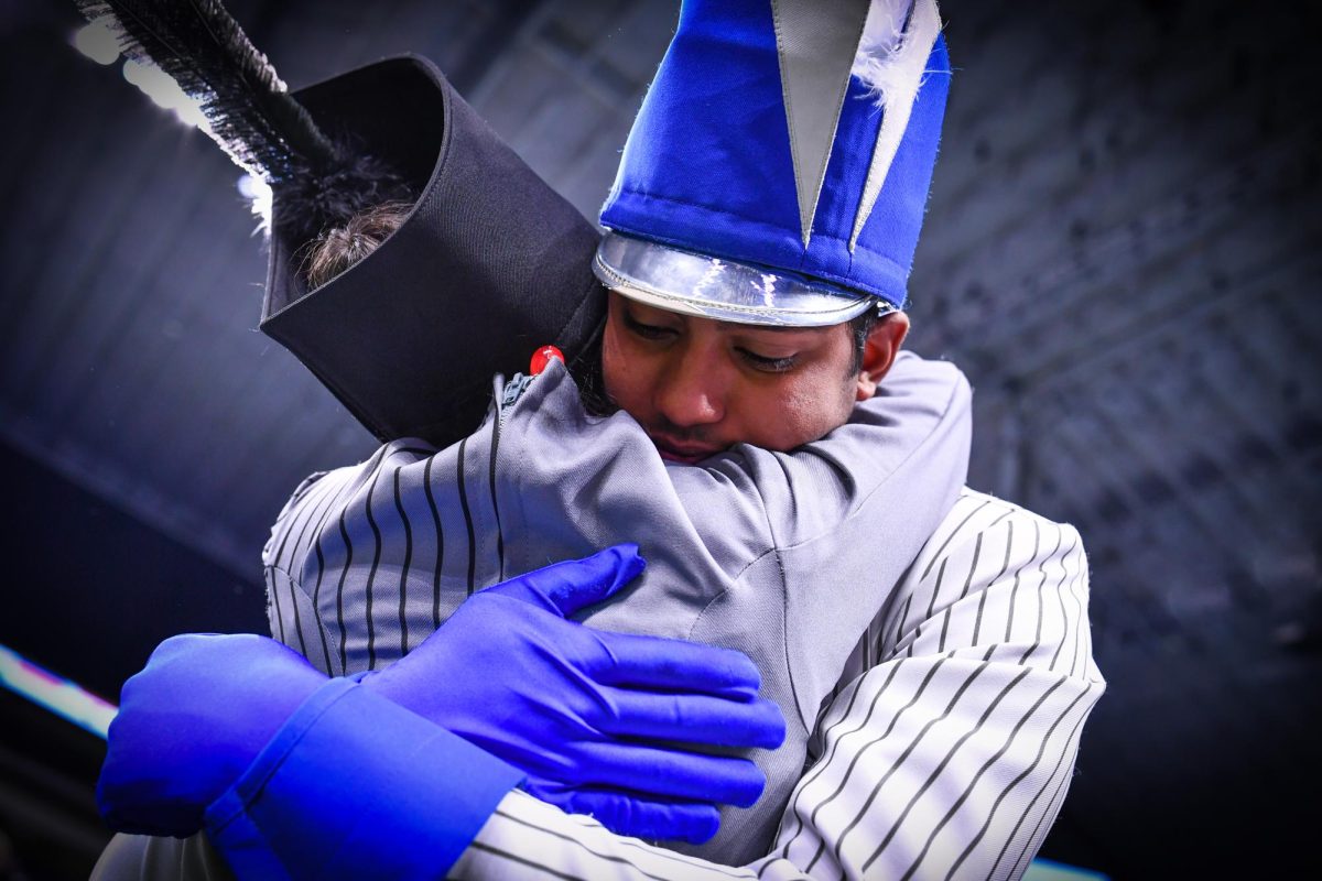 D’sa hugs junior drum major Noorain Aziz after the band placed second at the UIL State Marching Championship in 2022. He has been a part of the band since sixth grade, and plans to continue marching and major in architecture after high school.