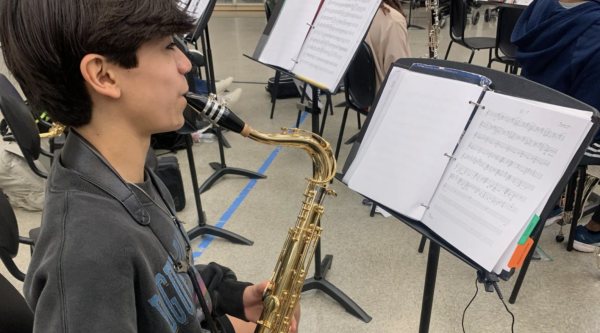 Freshman Ayden Garcia warms up on his instrument before band practice starts. He always makes sure to get a few minutes to himself, hooking up his tuner chord to his bell, making sure to perfect his sound before class starts.