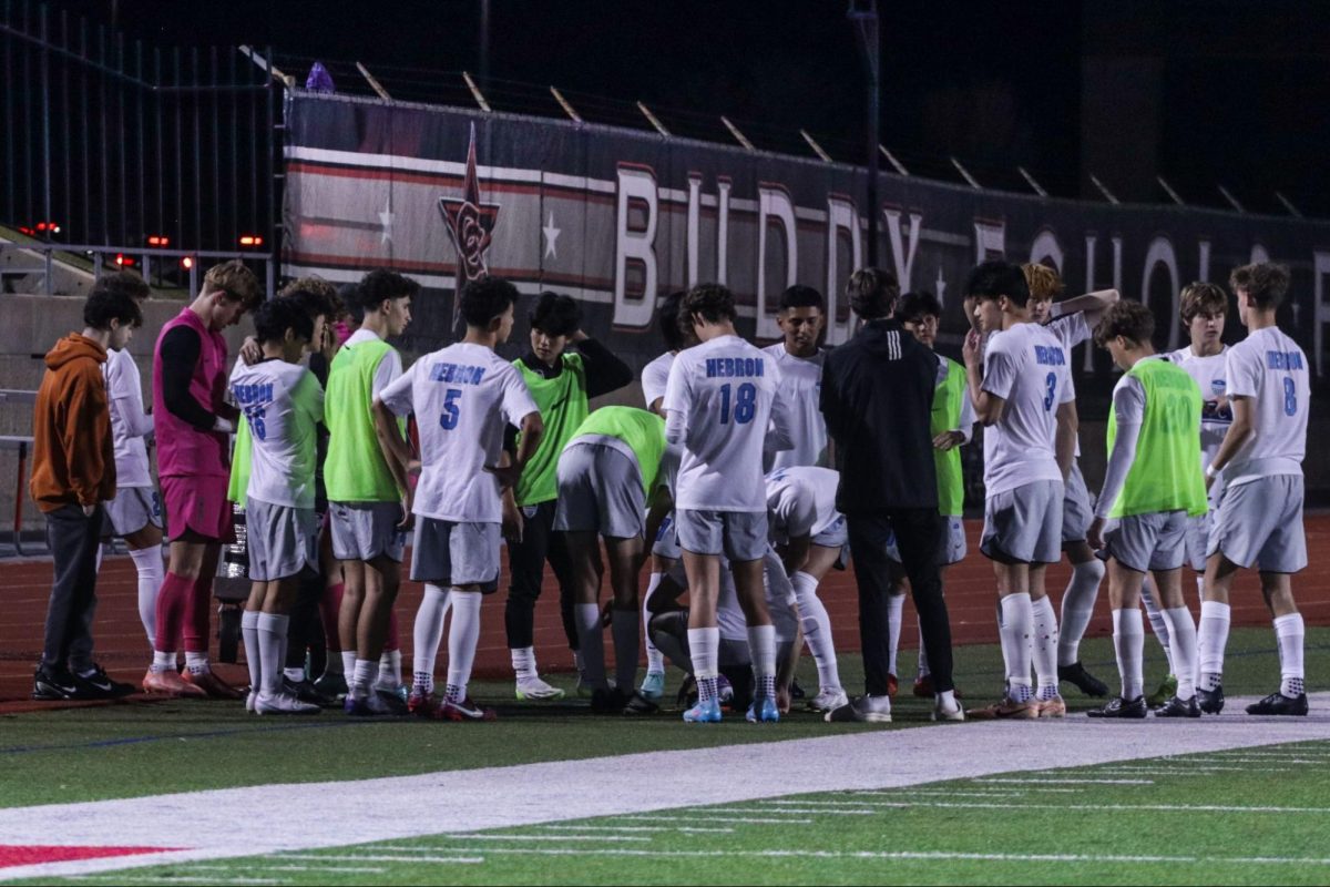 The boys soccer team talks before their game against the Coppell Cowboys. The Hawks played at the Buddy Echols Stadium, and lost 0-3.
