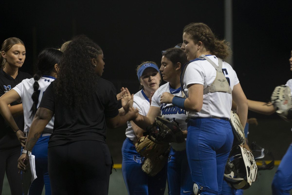 The team huddles with their coaches to discuss the game plan. This was the first district game of the 2022-2023 season against Marcus on March 6.