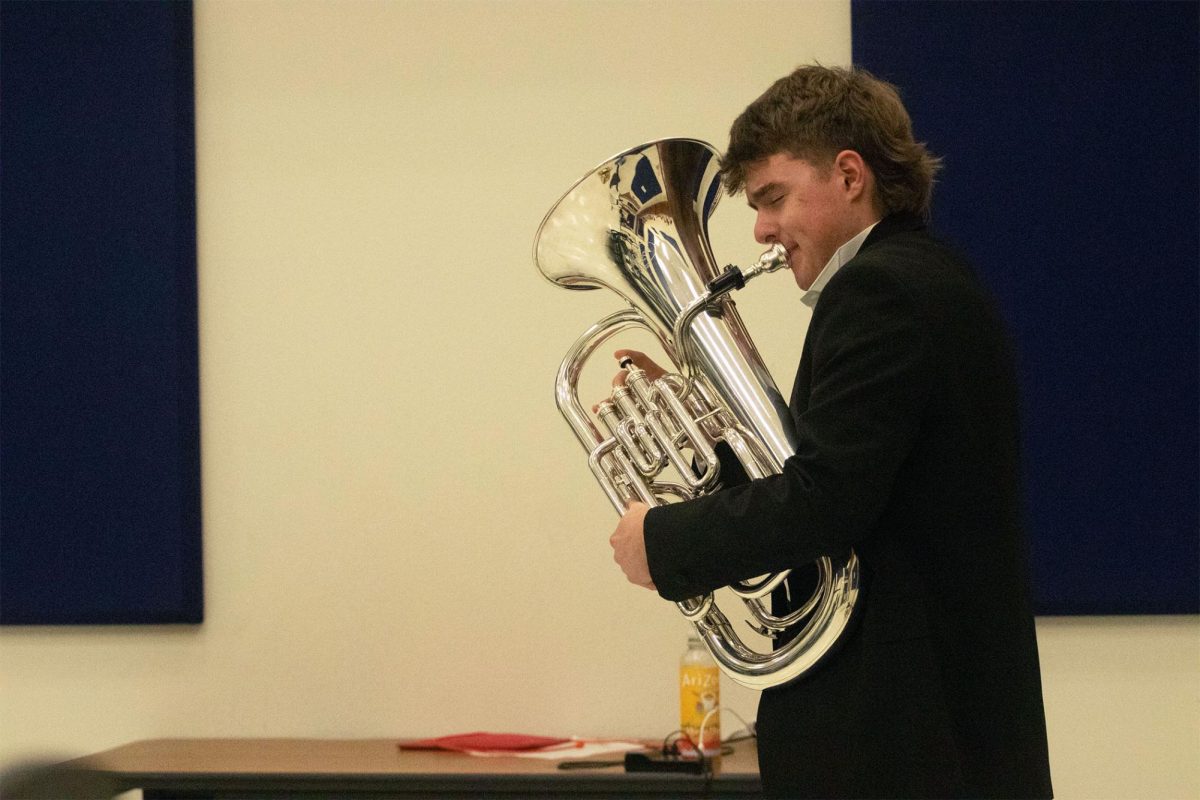 Freshman Eastin Baker practices his solo in the HHS9 choir room to prepare for his performance. The solo was titled “Cello Suite #1.”