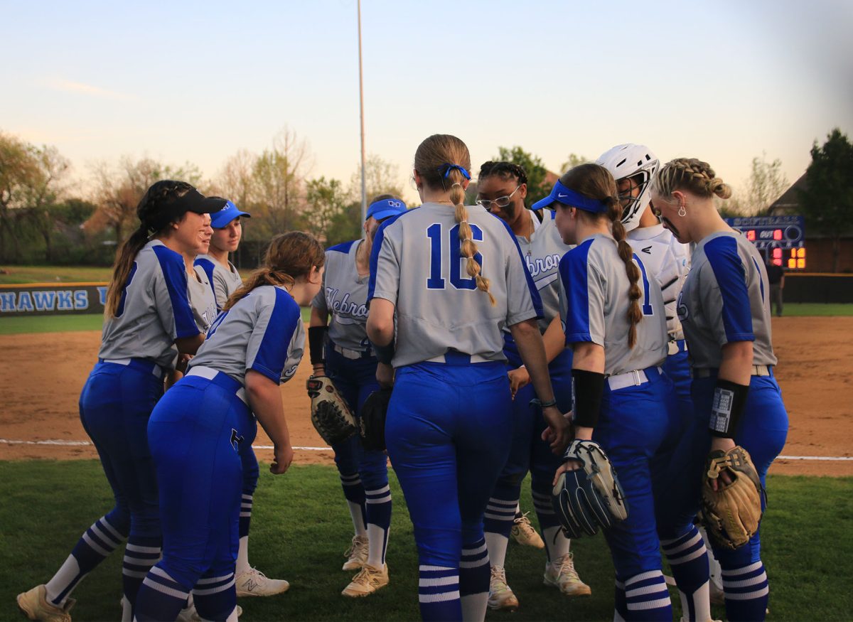The team gathers in huddle to hype each other up before running onto the field and getting to their respective positions. The Lady Hawks are currently third in the district behind Marcus.