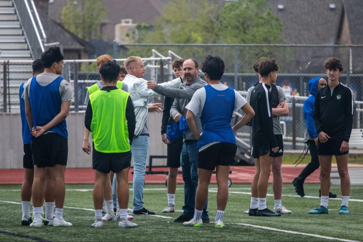Head coach Matt Zimmerman instructs the boys soccer team on specific drills in preparation for the first playoff game on March 25. They were practicing corner kicks and blocking to use against McKinney Boyd.
