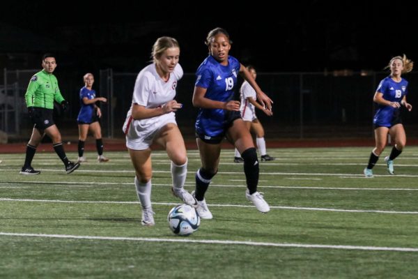 Junior Layla Thompson races toward the ball with a Coppell midfielder during the Lady Hawks game on Feb. 6. The team won 3-1. 