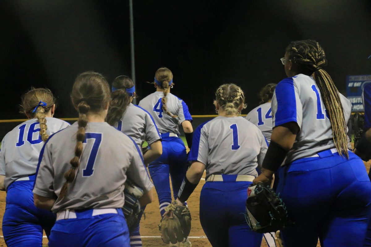The team runs onto the field to get into their respective positions against Marcus High School on March 28. The Lady Hawks lost the game 2-1, but followed with a six-game winning streak to end the district season.