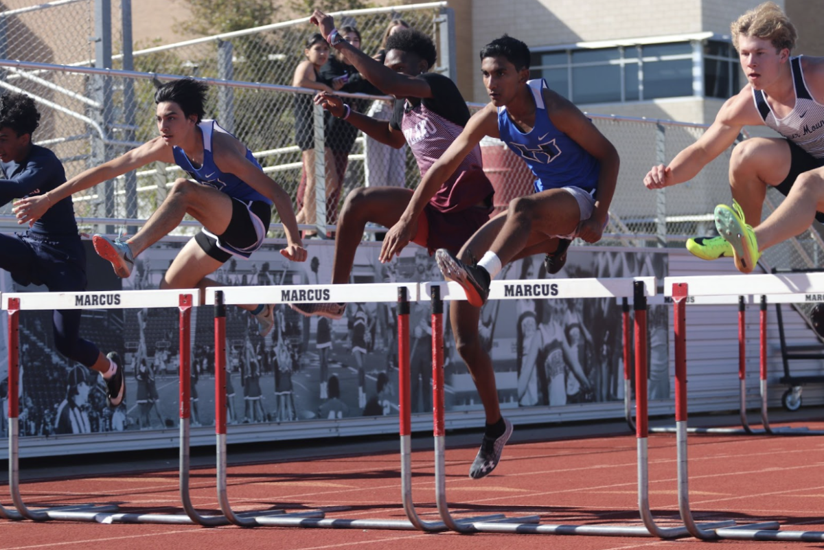 (Left to right) Freshman Ethan Jacob and freshman Carter Nichols run the 110 Hurdles. Jacob ran in lane six and Nickels in lane four. 