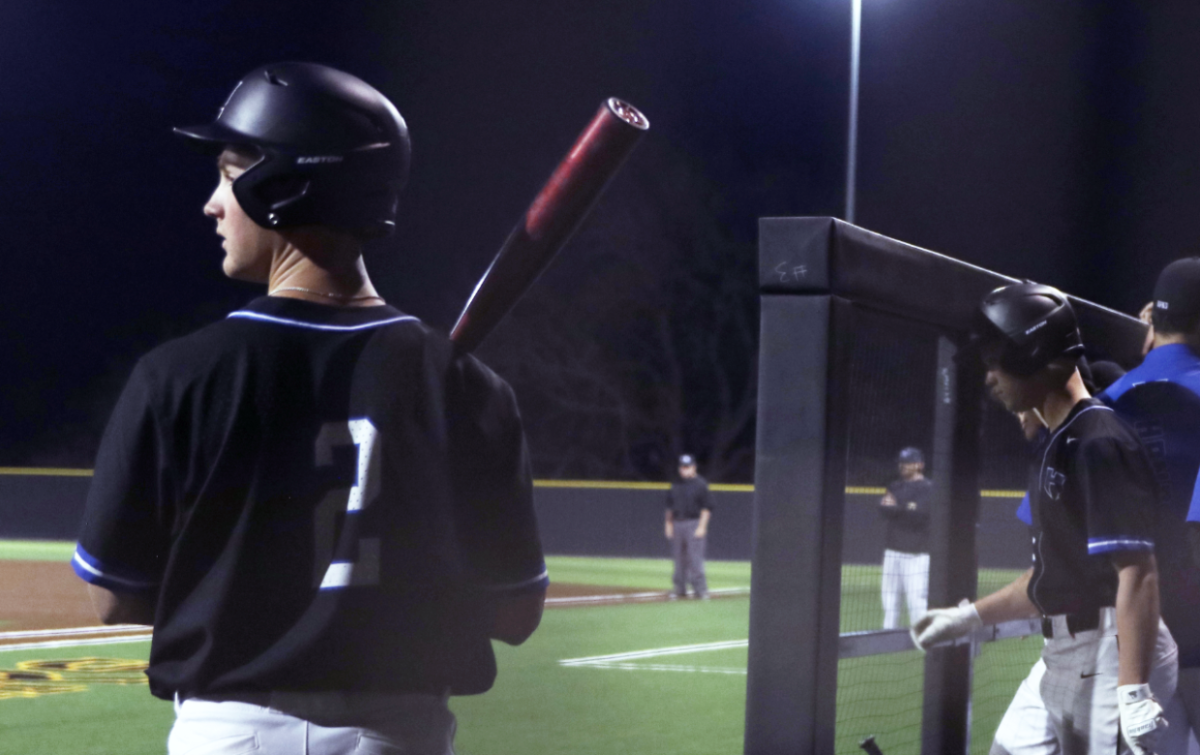 Outfielder Lance Young stands in the dugout, waiting for his turn to bat. Young has been playing baseball since he was 4 years old and said that with a new head coach, he’s been adjusting from former head coach Steve Stone’s teaching style to this year’s head coach, Corey Farra’s. 
