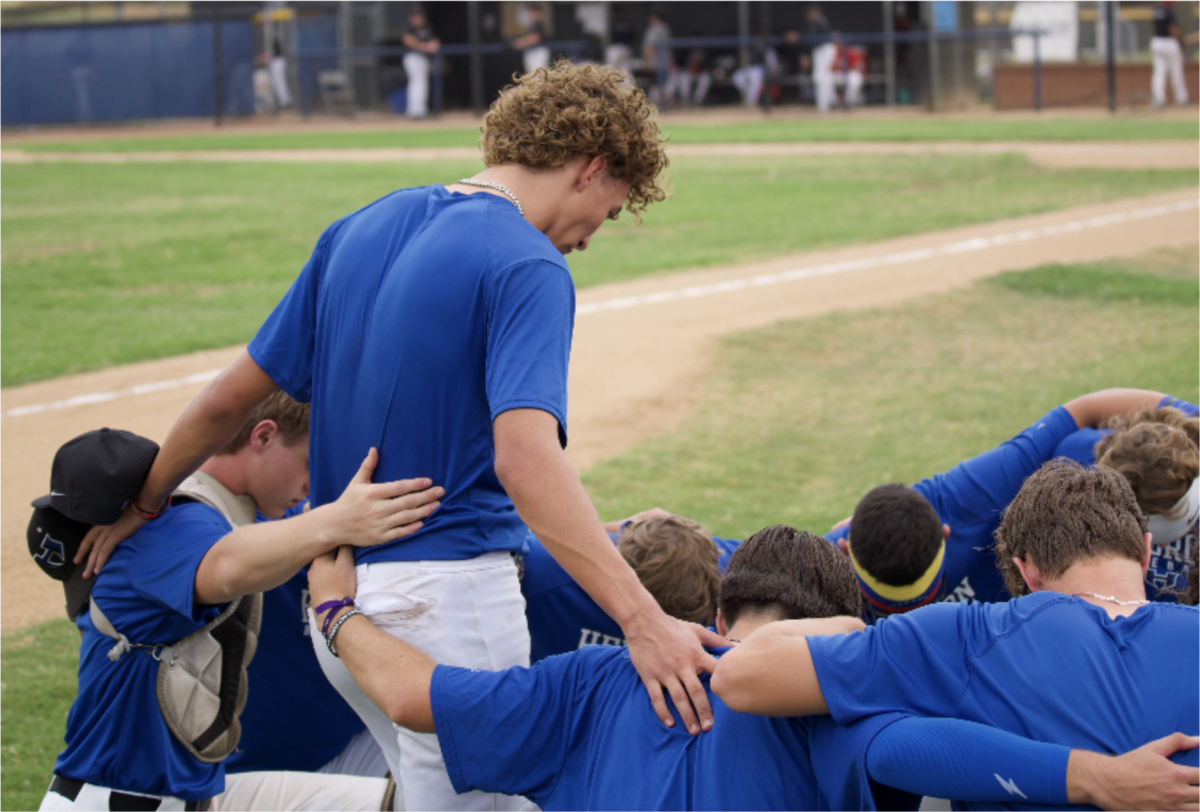 Junior Ethan Hunt prays over his team before a game. Hunt said he has been blessed by God to have the people he has in his life and commit as a junior. (Photo provided by Ethan Hunt.)