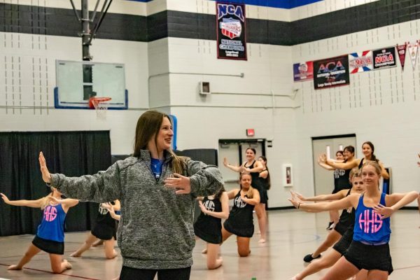  Interim head director of Silver Wings Lauren Wheeler shows her students how to do a move during 1st period practice on April 23. Wheeler started this year off as the assistant director and, following the departure of the head director, took over as interim head director. 