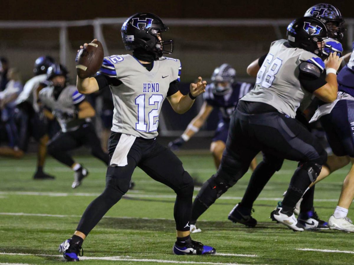 Quarterback Brady Brock throws the ball during the team’s last district game against Flower Mound. The team won the game 38-7, leaving them fourth in district to qualify for the playoffs.