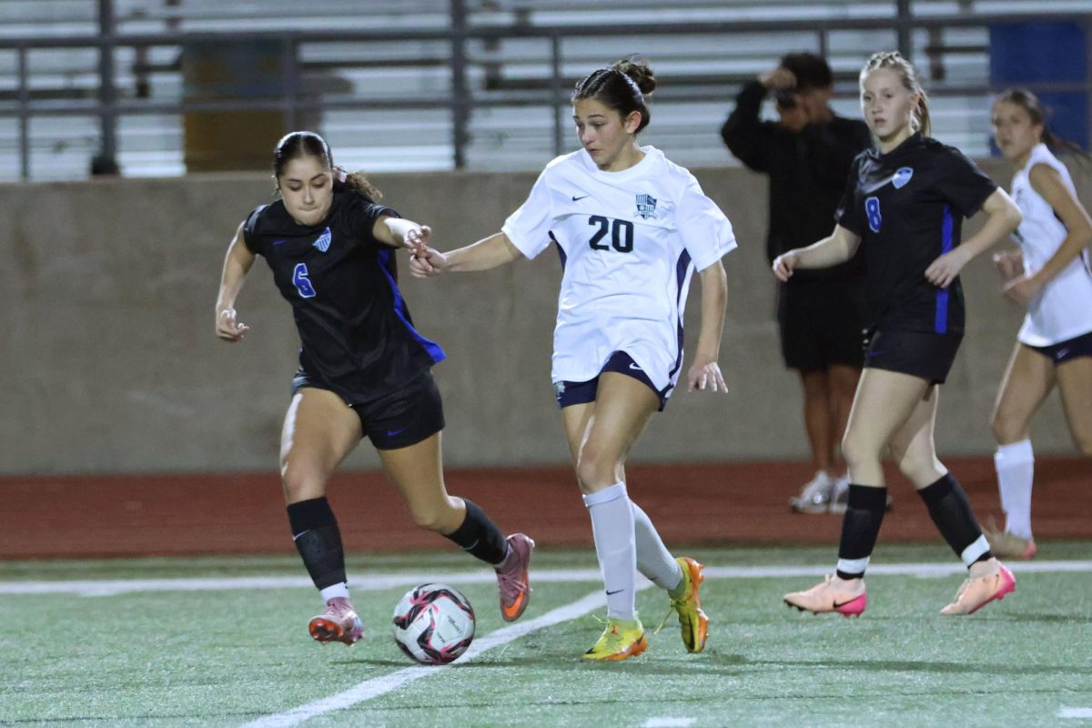 Midfielder Aubree Apodaca steals the ball from an opposing midfielder during the first half against Reedy Dec. 12. Apodaca is one of three freshmen on the team.