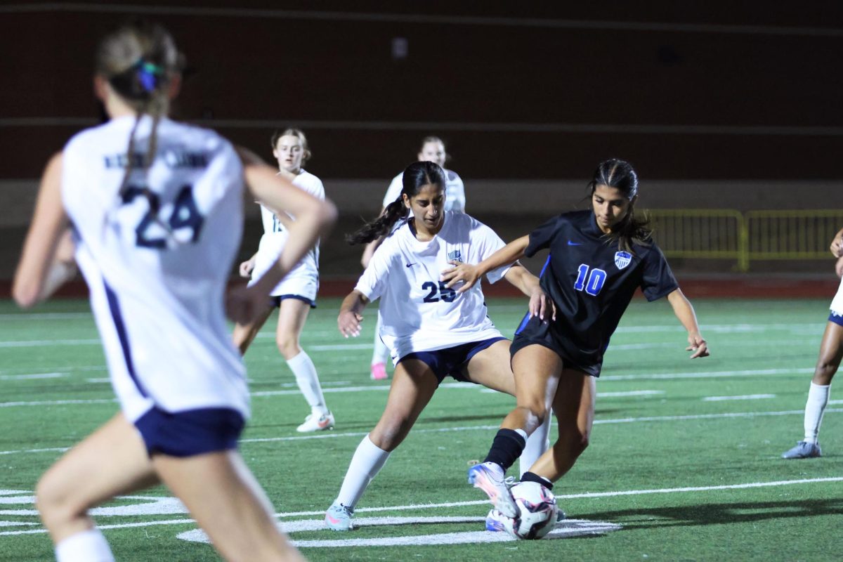 Forward Zoe Puente defends the ball against Reedy Dec. 12 at Brian Brazil Stadium. She successfully stole the ball and passed it forward.