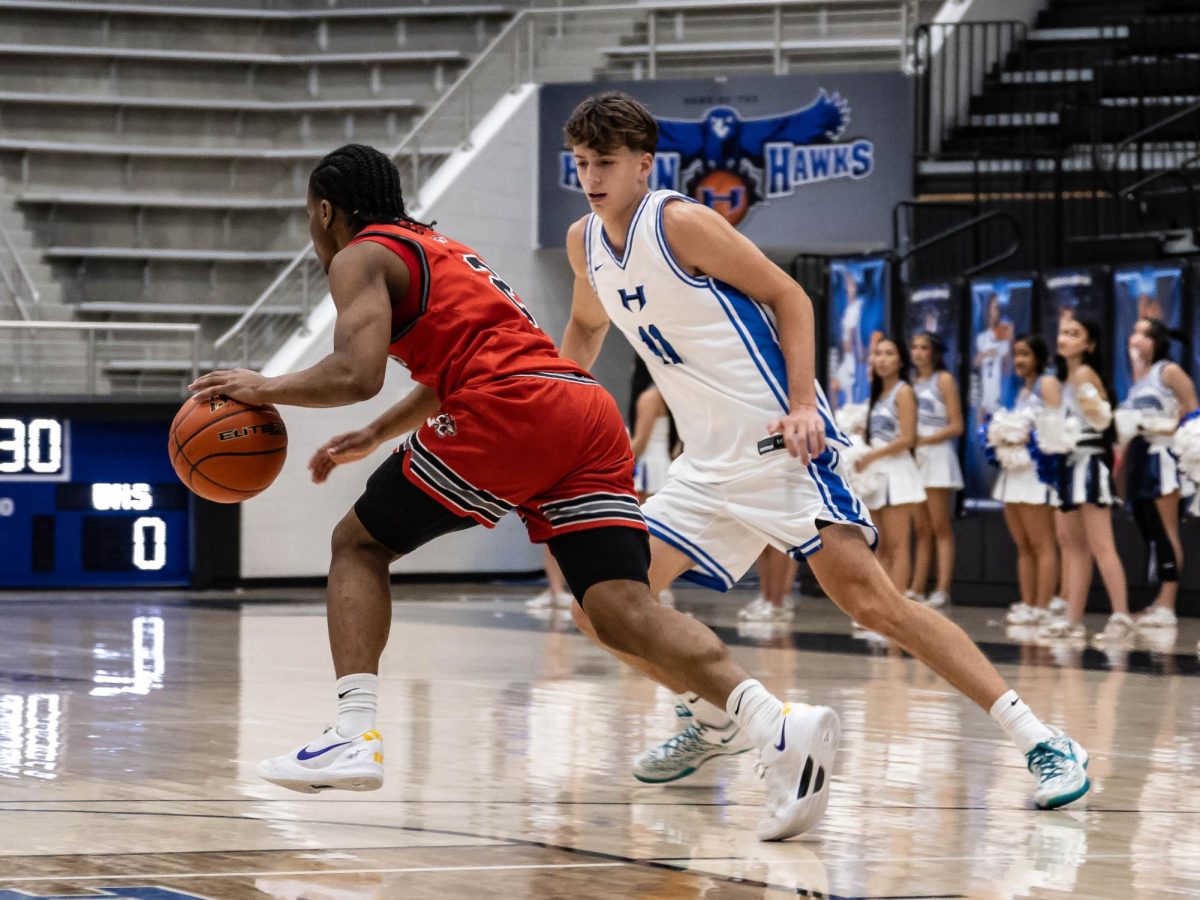 Guard Jake Pope defends against a Braswell player during the first quarter. The Hawks won the game 56-52, placing them sixth in the district. 
