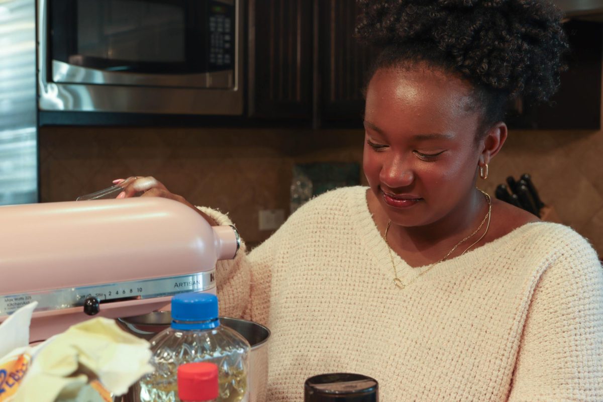 Junior Eden Brown mixes ingredients in her family’s mixer to make homemade cookies. She has owned her baking business for two years, adding cakes to the menu last month.