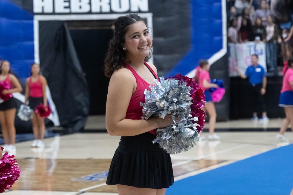 Senior Monica Ahadi performs with the Silver Wings at the “Pink Out” pep rally Oct. 17. This is her third year on Silver Wings.