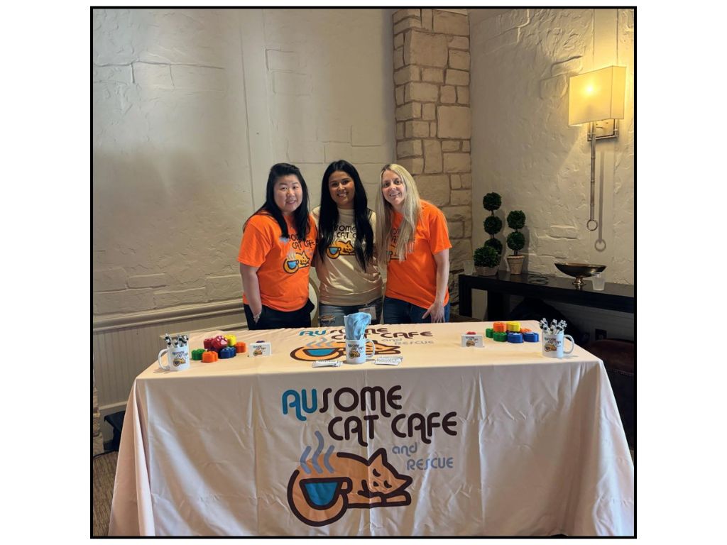 Three AUsome cat affiliates pose for a photo at an event. (Photo via AUsome Cat Cafe Facebook)
